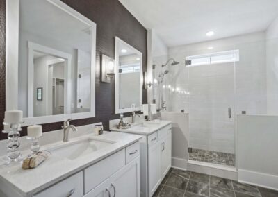 upscale white jack and jill bathroom with brown walls