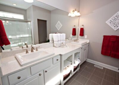 white bathroom with deep red towels